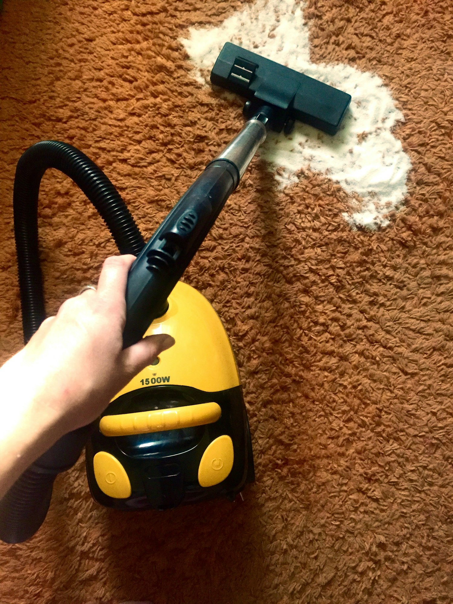 Vacuuming the flour spilled on the carpet